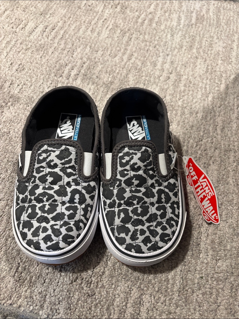 Vans Kids Slip-On Sneakers in Black and White Leopard Print
